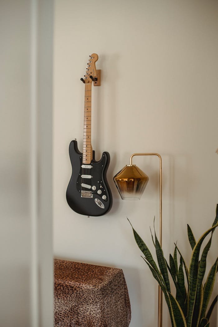 Rock guitar on wall in room at home